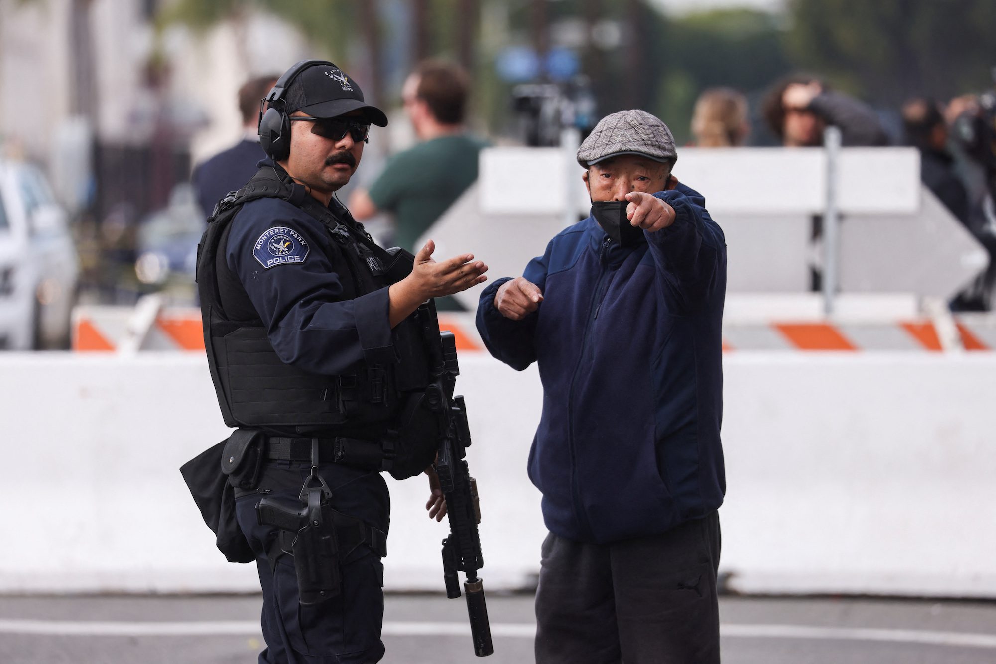 A man signals as a police officer directs him to walk away from the location of a shooting that took place during a Chinese Lunar New Year celebration, in Monterey Park, California, U.S. January 22, 2023. REUTERS/Mike Blake