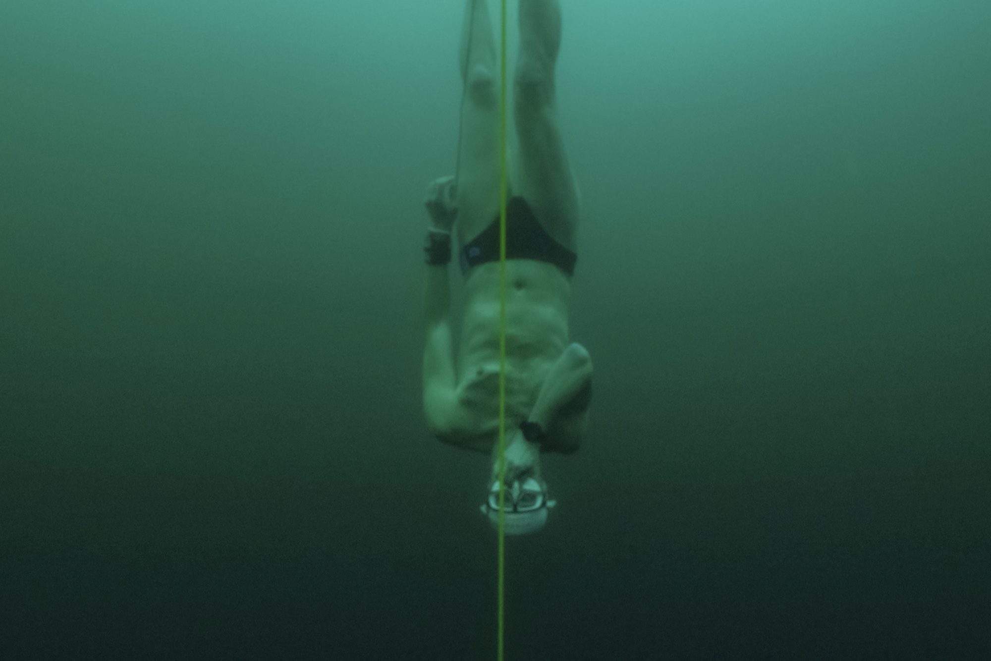 Czech freediver David Vencl dives to 52 metres under the ice of Lake Sils in one breath and wearing only a swimsuit in this picture taken from a video in Sils near St. Moritz, Switzerland March 14, 2023. David Vencl Organisation/Handout via REUTERS