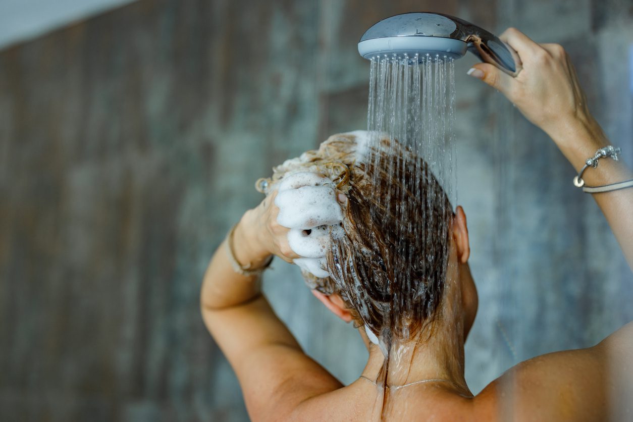 woman washing her hair with a shampoo