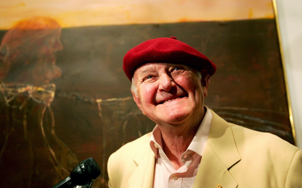 Australian artist Olsen stands in front of his painting during the winner's announcement of the 2005 Archibald Prize in Sydney.  Australian artist John Olsen stands in front of his painting "Self Portrait Janus Faced" during the winner's announcement of the 2005 Archibald Prize at the art gallery of New South Wales in Sydney April 29, 2005. 76-year-old Olsen won the A$35,000 ($27,240) prize in one of Australia's most prestigious art competitions. REUTERS/Tim Wimborne
