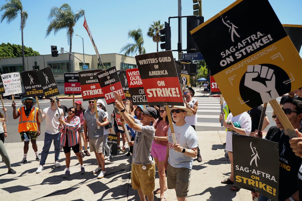 SAG-AFTRA actors and Writers Guild of America (WGA) writers walk the picket line during their ongoing strike outside Paramount Studios in Los Angeles, California, U.S., August 2, 2023. REUTERS/Mario Anzuoni