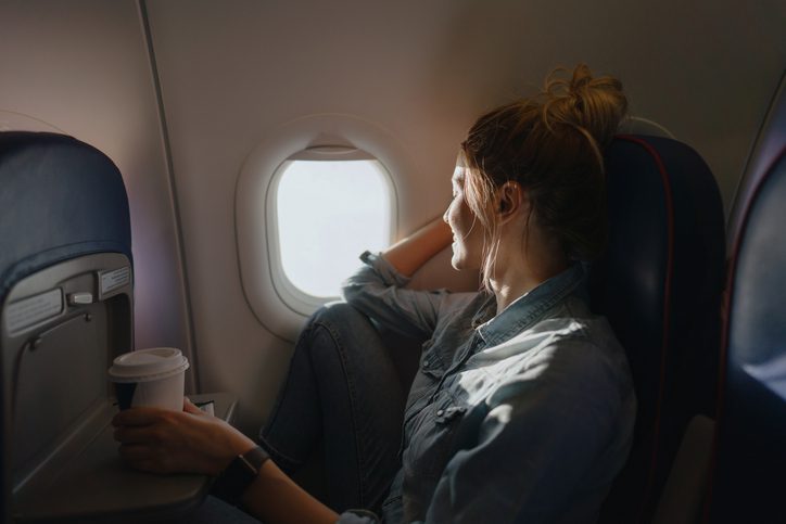 woman on plane looking out window