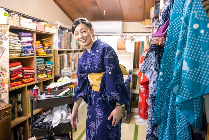 Japanese woman in yukata standing in fitting room