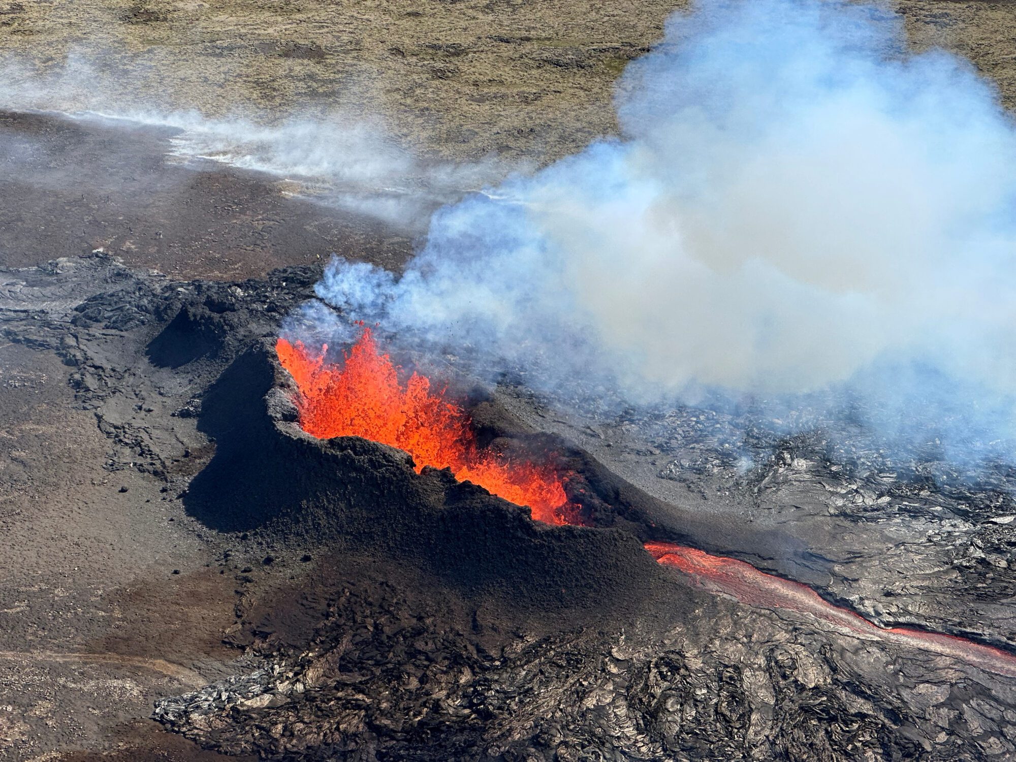FILE PHOTO: Lava spurts and flows after the eruption of a volcano in the Reykjanes Peninsula, Iceland, July 12, 2023, as seen in this handout picture taken from a Coast Guard helicopter. Civil Protection of Iceland/Handout via REUTERS    THIS IMAGE HAS BEEN SUPPLIED BY A THIRD PARTY. MANDATORY CREDIT/File Photo