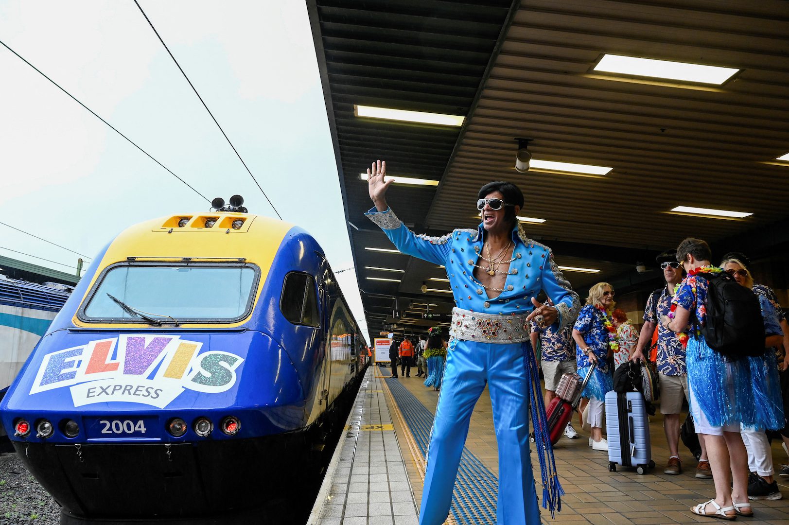 An Elvis Presley impersonator waves before boarding a train at Sydney Central Railway Station departing for the Parkes Elvis Festival, in Sydney, Australia, January 5, 2023.  REUTERS/Jaimi Joy/File Photo