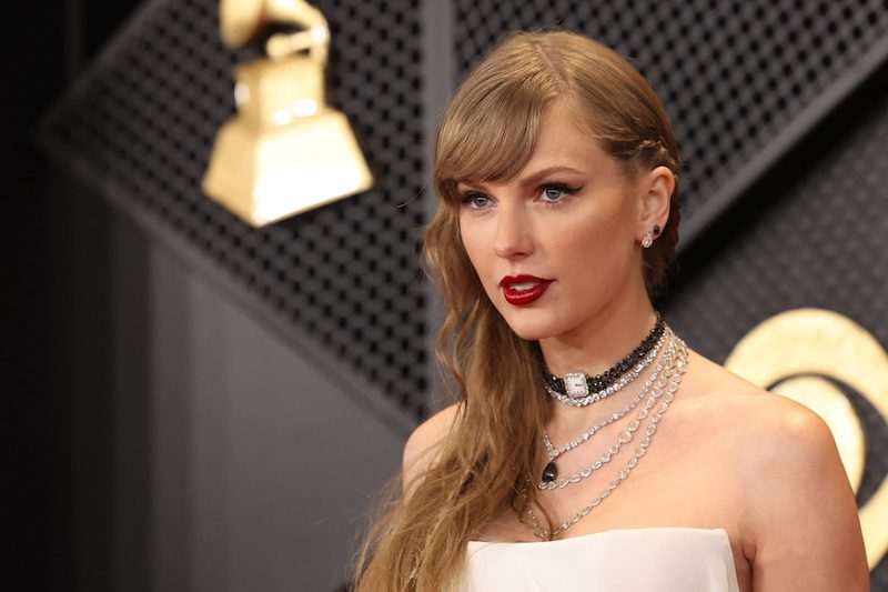 Taylor Swift poses on the red carpet as she attends the 66th Annual Grammy Awards in Los Angeles, California, U.S., February 4,