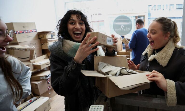 Chloe Boseret, 20, Hiba Did, 20 and Anouk Anglade react after opening a parcel at Pile ou Face. REUTERS/Yves Herman