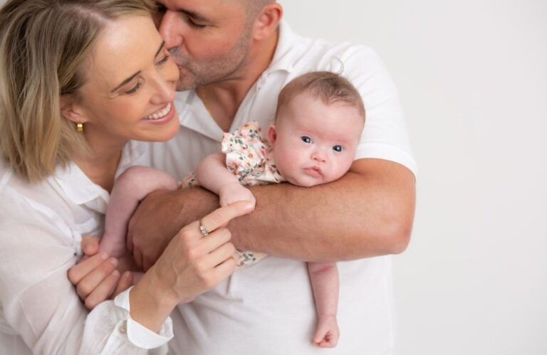 Six-month-old Amelia who was born with Down Syndrome, with her parents Lucy and Roberto. Image / Down Syndrome NSW