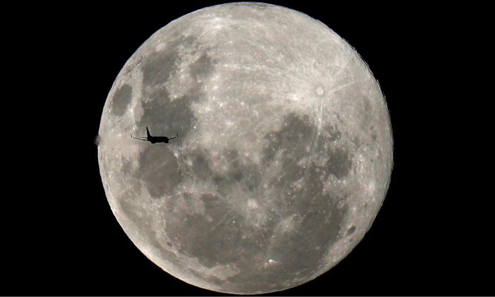 FILE PHOTO: A plane is pictured in front of the full moon in Curitiba, Brazil February 8, 2020. REUTERS/Rodolfo Buhrer