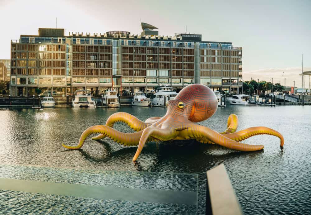 Te Wheke-a-Muturangi by Lisa Reihana, part of the Aotearoa Art Fair Sculpture Trail, creeps across the water of the Viaduct Harbour. Photo / Jeremy Ho