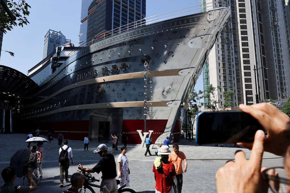 People take photos of the new Louis Vuitton store in Shanghai, China, June 27, 2025. REUTERS/Go Nakamura     TPX IMAGES OF THE DAY