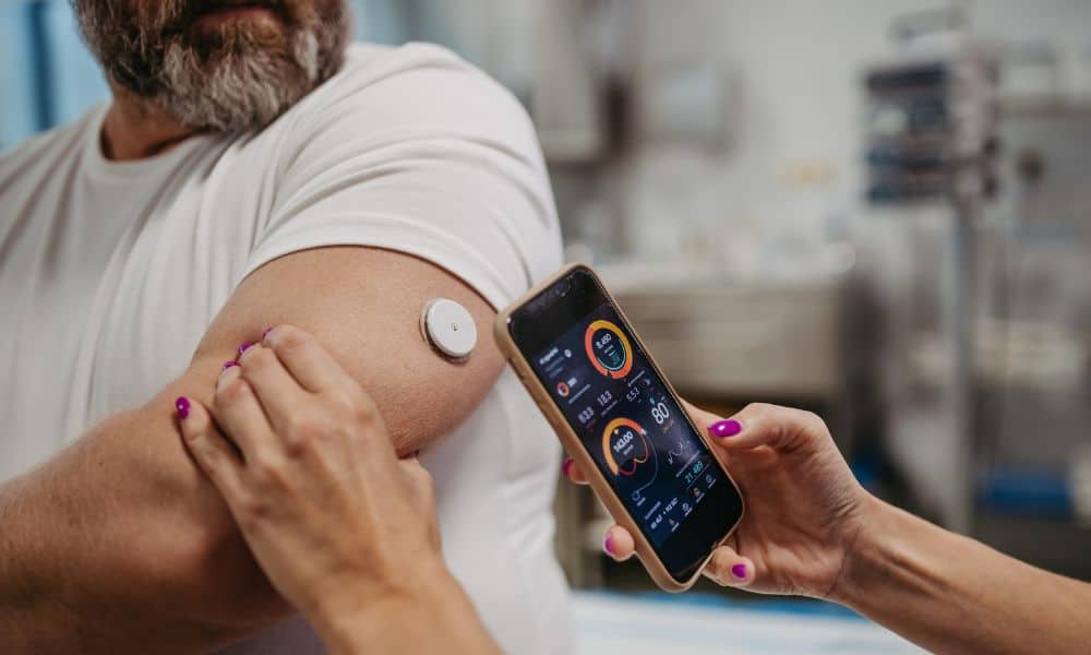 A man having his continuous glucose monitor checked by his doctor.