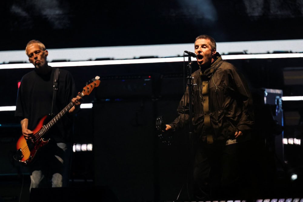 Liam Gallagher and Gem Archer of Oasis perform, during the first of their sellout comeback shows, at the Cardiff Principality Stadium, in Cardiff, Wales, Britain, July 4, 2025. REUTERS/Suzanne Plunkett