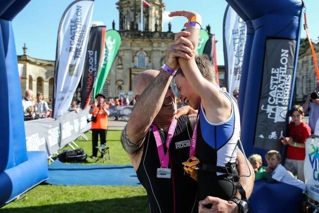 Bailey celebrates with his Dad Jonathan at the finishing line of the Castle Howard Triathlon. 

Ross Parry / SWNS Group