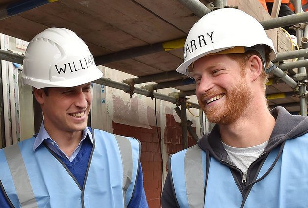 Britain's Prince William,  left,  and Prince Harry smile  during a visit to a building site in Manchester England. Wednesday Sept. 23, 2015.  (Andy Stenning/Pool via AP)