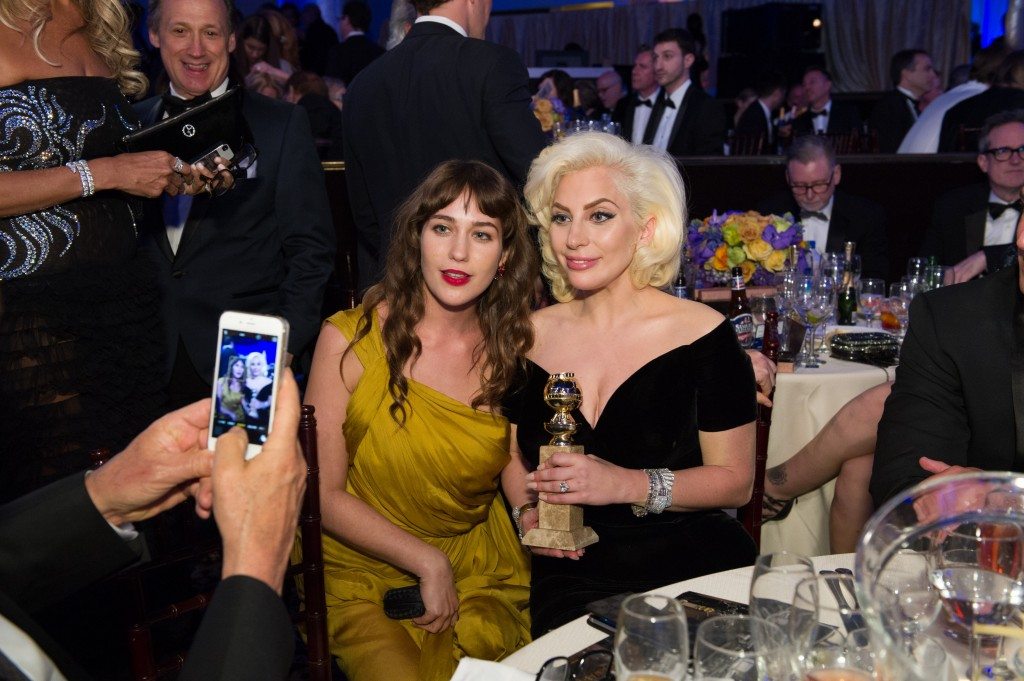 After winning the category of BEST PERFORMANCE BY AN ACTRESS IN A MINI-SERIES OR MOTION PICTURE MADE FOR TELEVISION for her role in "American Horror Story: Hotel," actress Lady Gaga poses with her Golden Globe Award with actress, Lola Kirke at the 73rd Annual Golden Globe Awards at the Beverly Hilton in Beverly Hills, CA on Sunday, January 10, 2016.