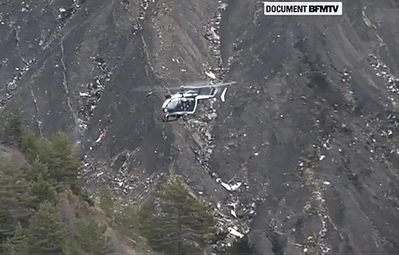 A rescue helicopter from the French Gendarmerie hovers in front of the crash site. 