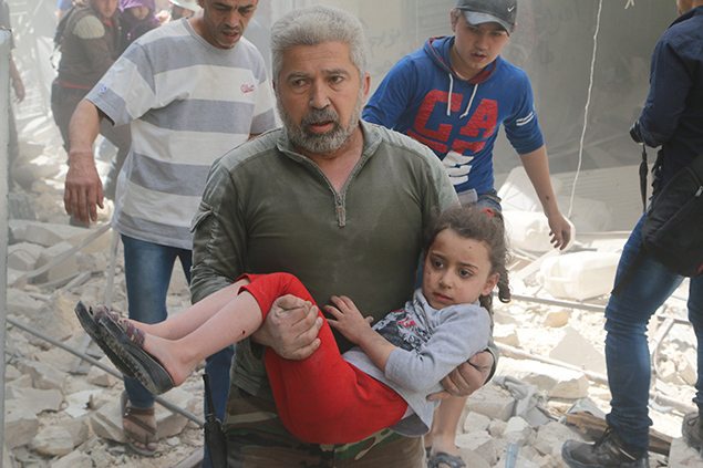 A man carries an injured girl after an airstrike in the rebel held area of old Aleppo, Syria.
REUTERS/Abdalrhman Ismail. 