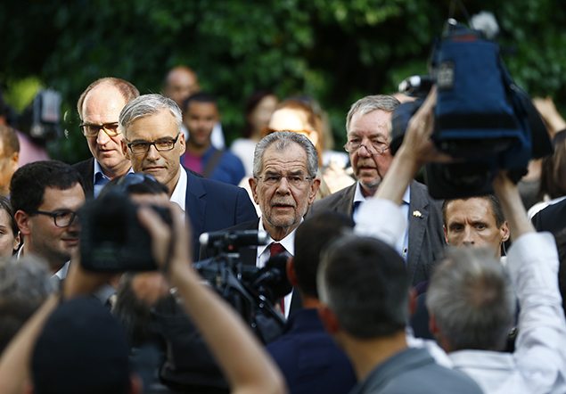 Left-wing independent candidate Alexander Van der Bellen (C) is surrounded by supporters and media after winning the Austrian presidential election,  REUTERS/Leonhard Foeger.