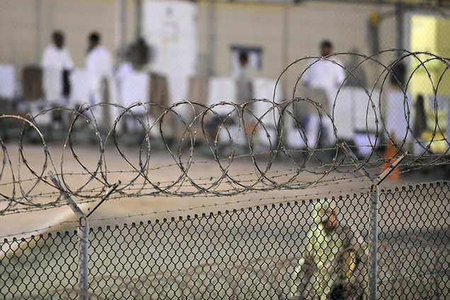 A Navy guard patrols Camp Delta's detainee recreation yard during the early morning at Guantanamo Bay.
REUTERS.
