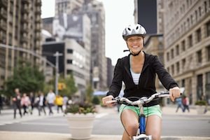 Portrait of woman riding bicycle on city street