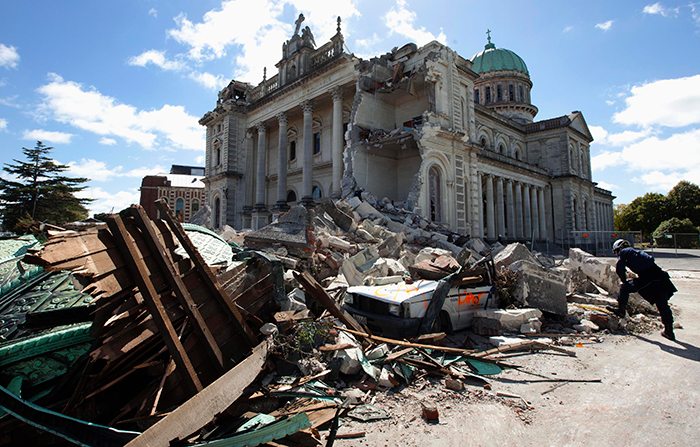 A rescue worker looks through the rubble of the Cathedral of Blessed Sacrament in Christchurch. Retuers
