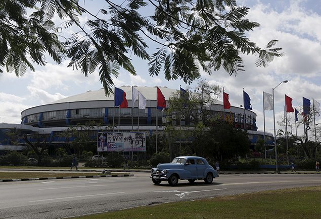 A car drive past the building of the Ciudad Deportiva de la Habana, sports complex, where the Rolling Stones will perform a free outdoor concert. REUTERS/Enrique de la Osa 