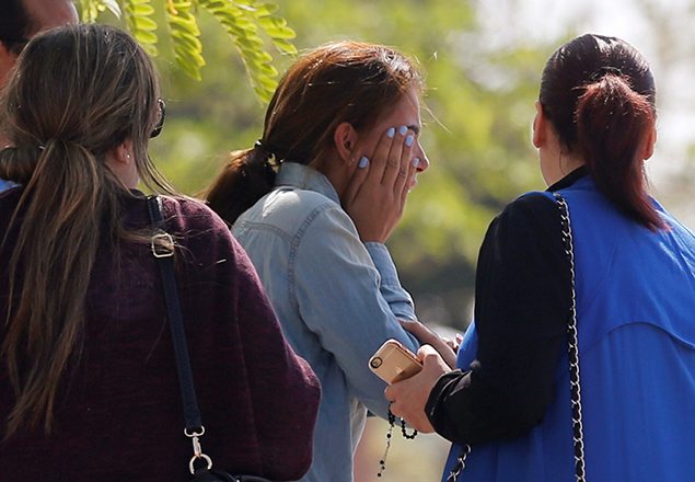 Unidentified relatives and friends of passengers who were flying in an EgyptAir plane that vanished from radar en route from Paris to Cairo react as they wait outside the Egyptair in-flight service building where relatives are being held at Cairo International Airport.    REUTERS/Amr Abdallah Dalsh