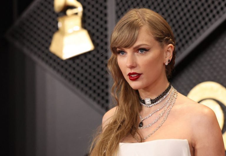 Taylor Swift poses on the red carpet as she attends the 66th Annual Grammy Awards in Los Angeles, California, U.S., February 4,