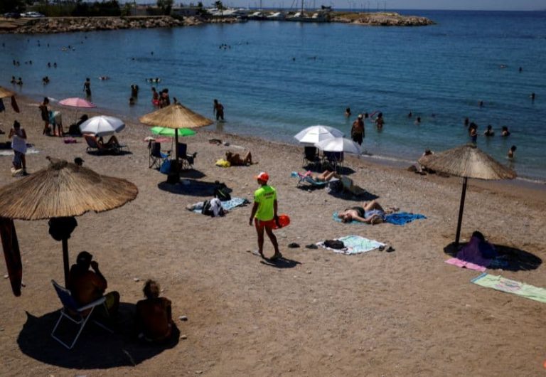 A lifeguard walks on Glyfada beach as people try to cool off at the sea during a heatwave in Athens, Greece, July 8, 2025. Photo / Reuters