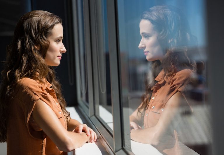 Side view of thoughtful businesswoman looking through window