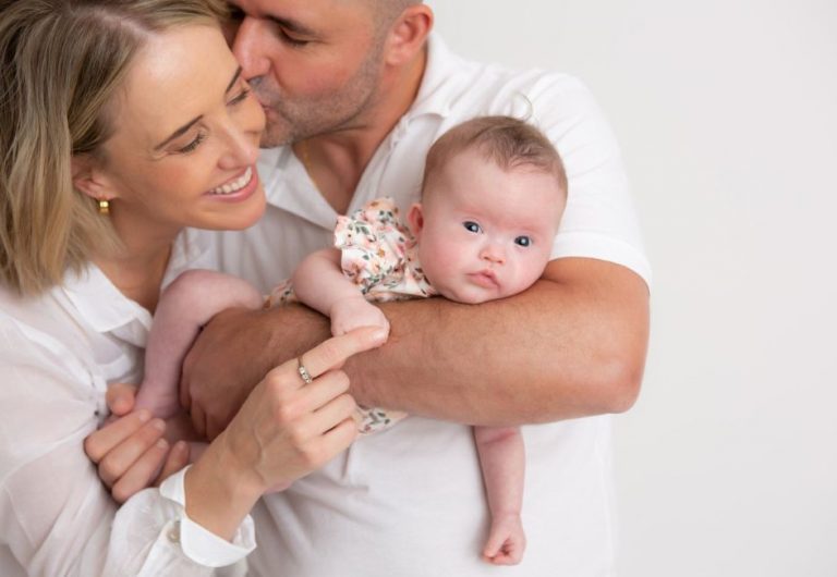 Six-month-old Amelia who was born with Down Syndrome, with her parents Lucy and Roberto. Image / Down Syndrome NSW