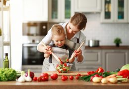 happy family mother with child son preparing vegetable salad