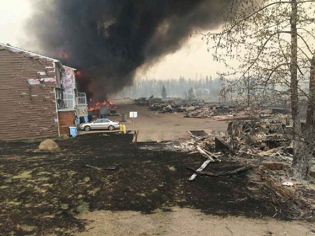 Smoke rises in a burned-out neighbourhood in Fort McMurray, Alberta.