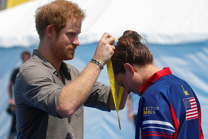Britain's Prince Harry presents Elizabeth Marks of the U.S. a gold medal during a medal ceremony at the Invictus Games in Orlando, Florida, U.S., May 11, 2016. REUTERS/Carlo Allegri