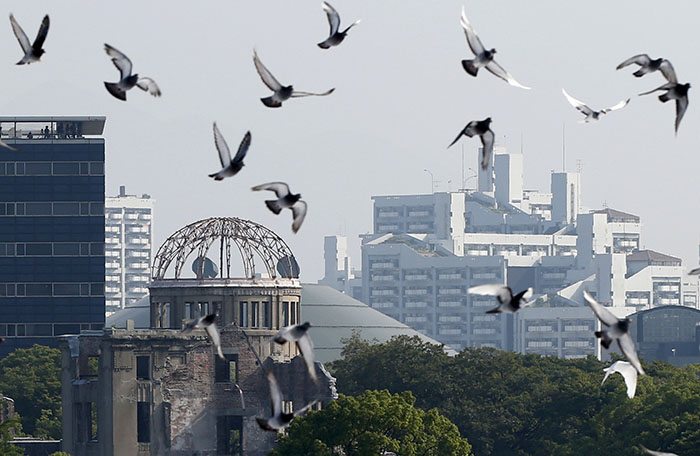 Doves fly over Peace Memorial Park near Atomic Bomb Dome at a 70th anniversary ceremony in Hiroshima REUTERS/Toru Hanai