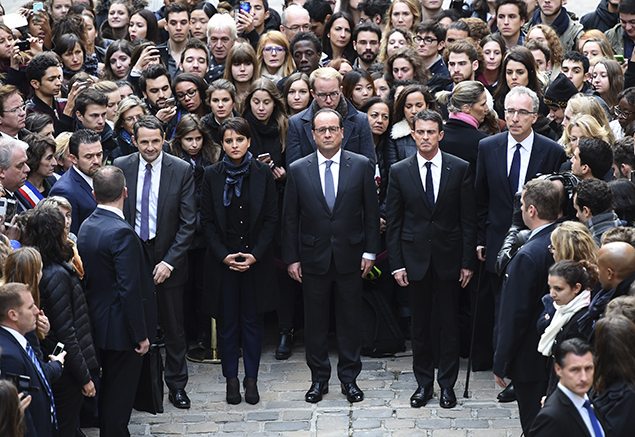 French president Francois Hollande and French Prime Minister Manuel Valls (middle and right) stand with other ministers as they observe a minute of silence at the Sorbonne University in Paris to pay tribute to victims of Friday's Paris attacks.
REUTERS/Stephane de Sakutin