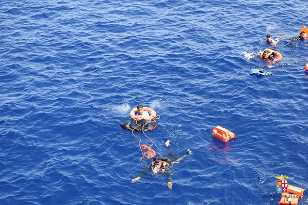 Migrants from a capsized boat are rescued off the coast of Libya.