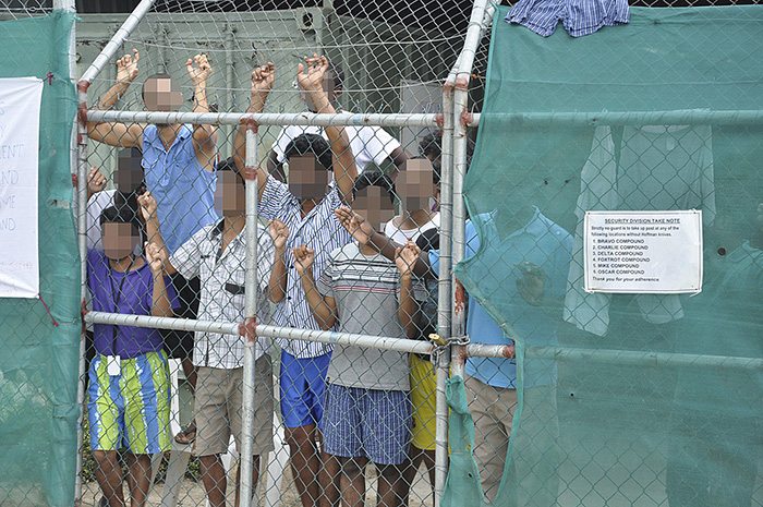 Asylum-seekers look through a fence at Australia's Manus Island detention centre, which the Australian and Papua New Guinea governments say will be closed. Picture Reuters
