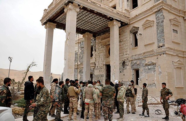 Forces loyal to Syria's President Bashar al-Assad gather at a palace complex on the western edge of Palmyra. REUTERS