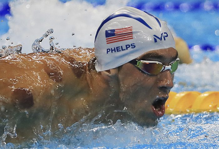 US swimmer Michael Phelps is seen with red cupping marks on his shoulder as he competes. Photo: Reuters