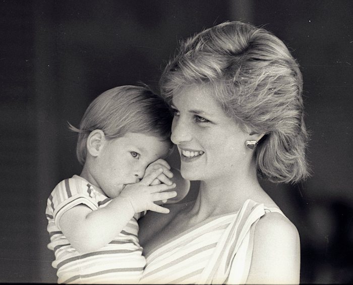 Young Prince Harry tries to hide behind his mother Princess Diana during a morning picture session at Marivent Palace on August 9, 1988, where the Prince and Princess of Wales are holidaying as guests of King Juan Carlos and Queen Sofia.    REUTERS/Hugh Peralta 