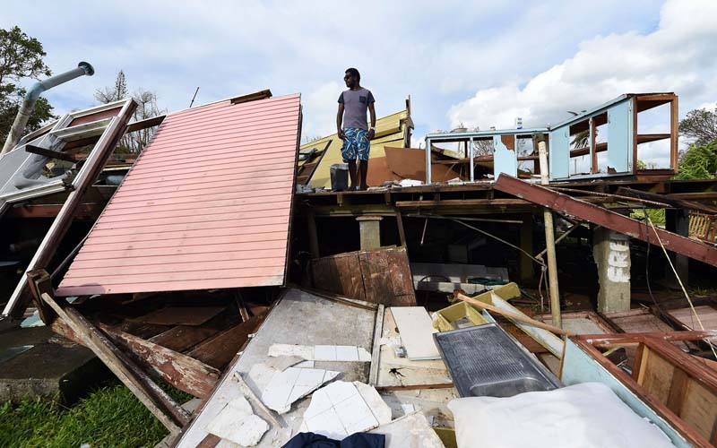 Local resident Adrian Banga stands his home destroyed by Cyclone Pam in Port Vila, the capital city of the Pacific island nation of Vanuatu