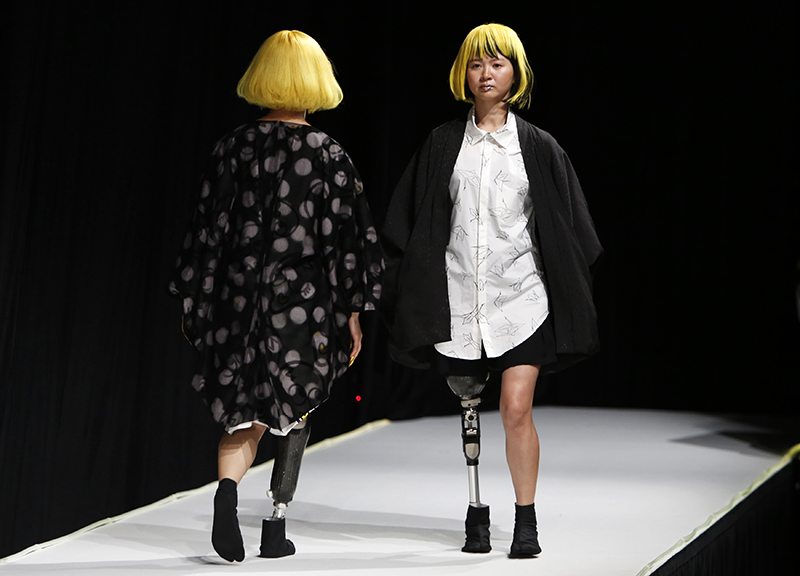 Models with prosthetic legs present creations by designer Takafumi Tsuruta from his Autumn/Winter 2015/2016 collection for his brand tenbo during Tokyo Fashion Week