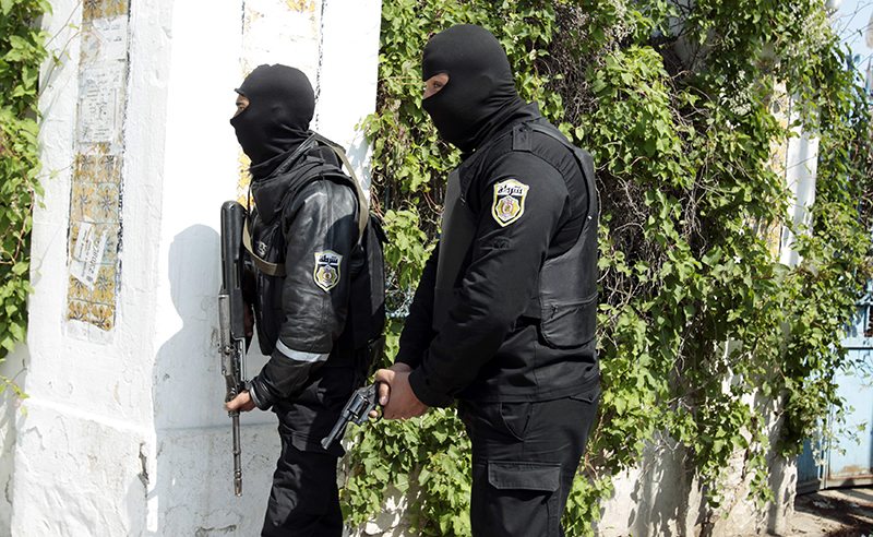 Police officers stand outside parliament in Tunis March 18, 2015. Gunmen attacked Tunisia's national museum near its parliament on Wednesday, killing at least 19 tourists and taking others hostage inside the building, the government said