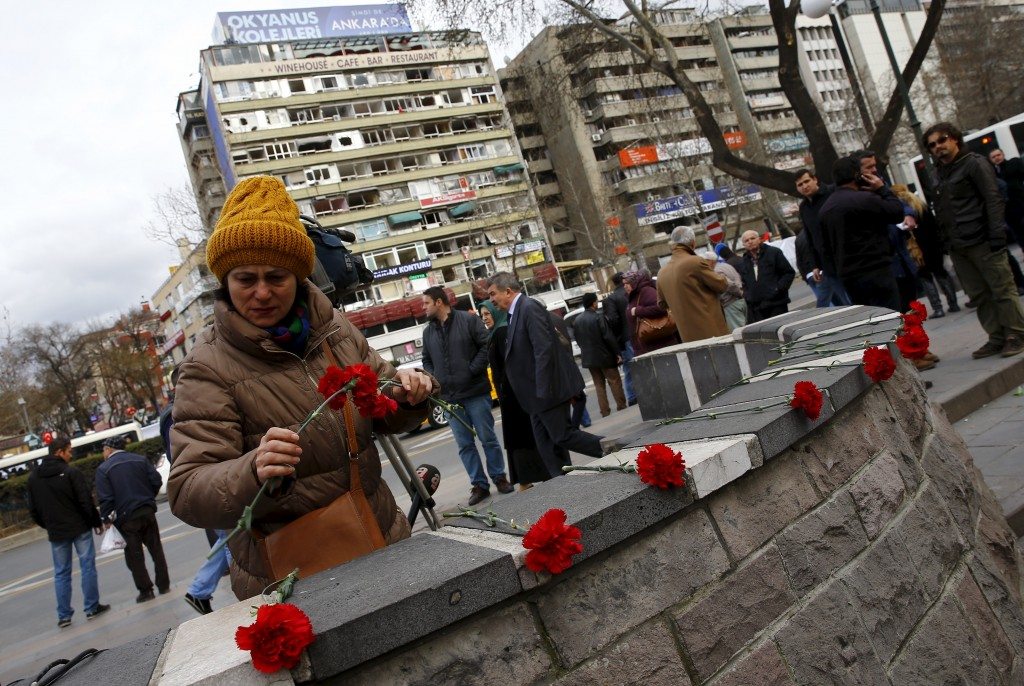A woman places carnations at the site of Sunday's suicide bomb attack in Ankara, Turkey, March 15, 2016. REUTERS/Umit Bektas