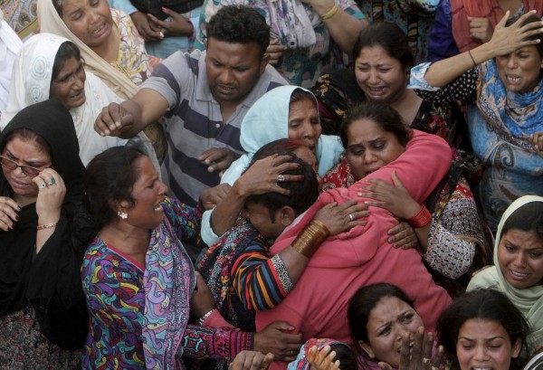 Family members mourn death of relative, who was killed in a blast outside a public park on Sunday, during funeral in Lahore. REUTERS/Mohsin Raza