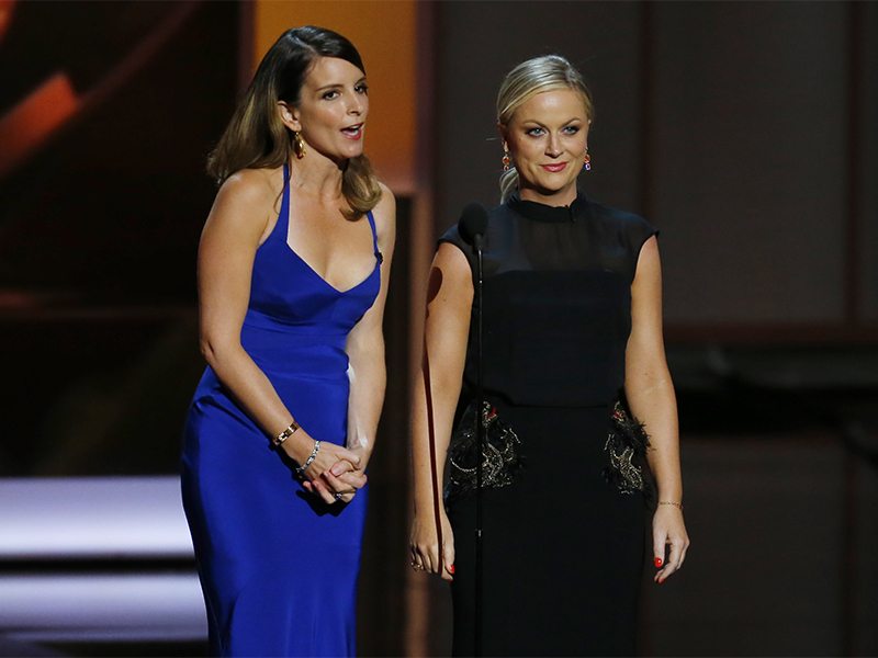 Tina Fey (L) and Amy Poehler present the award for Outstanding Supporting Actress In A Comedy Series at the 65th Primetime Emmy Awards in Los Angeles.