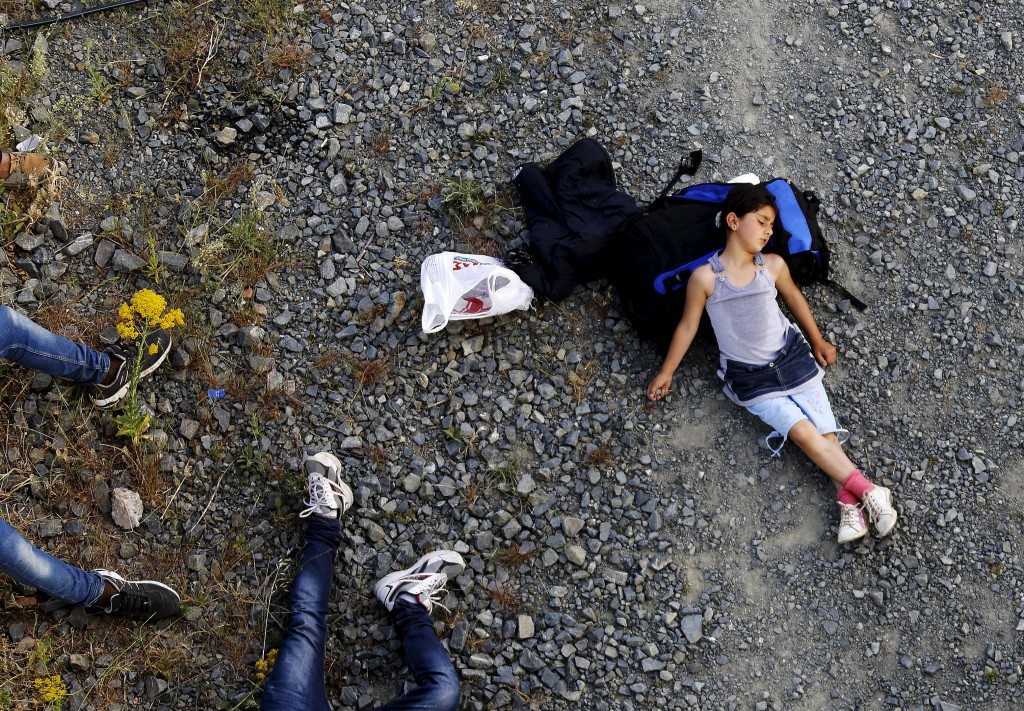 Seven year-old Ariana, a Kurdish-Syrian immigrant, rests before crossing into Macedonia along with another 45 Syrian immigrants near the border Greek village of Idomeni in Kilkis prefecture. REUTERS/Yannis Behrakis 