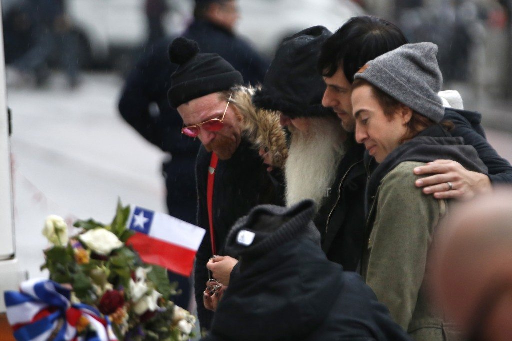 (L-R) Jesse Hughes, Dave Catching, Matt McJunkins and Julian Dorio, members of Eagles of Death Metal band, mourn in front of the Bataclan concert hall in Paris, France, December 8, 2015. REUTERS/Charles Platiau 